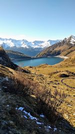 Scenic view of lake and snowcapped mountains against sky