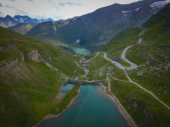 Scenic view of river amidst mountains against sky