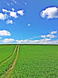 Scenic view of field against cloudy sky