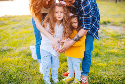 Full length of mother with daughter on field