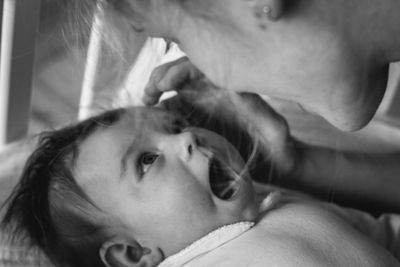 Side view of mother playing with daughter at home