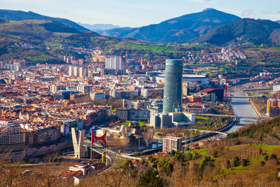 High angle view of townscape and mountains against sky