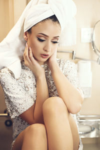 Close-up of young woman sitting at home