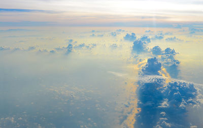 Aerial view of clouds over landscape during sunset