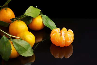 Close-up of orange fruit against black background