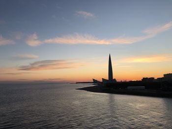 Silhouette of building against sky during sunset