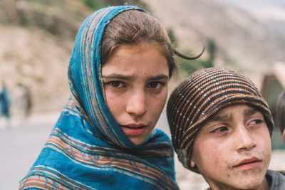 Close-up portrait of teenage girl with brother