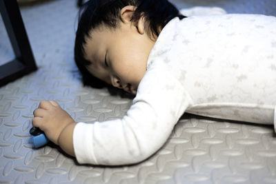 High angle view of boy sleeping on bed at home