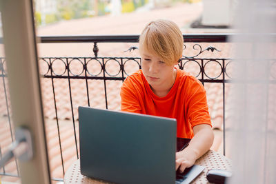 Young woman using laptop at home