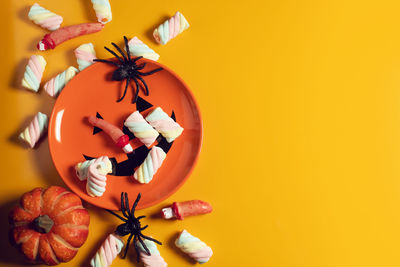 Close-up of pumpkins against orange background