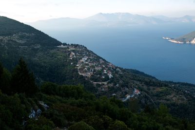 High angle view of townscape by mountain against sky