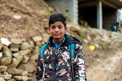 Portrait of boy standing outdoors