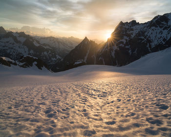 Scenic view of snowcapped mountains against sky during sunset