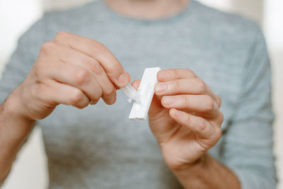 Midsection of man holding paper currency
