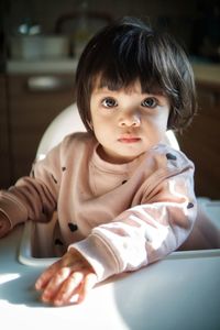 Portrait of cute baby girl at home