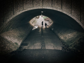 People standing in tunnel