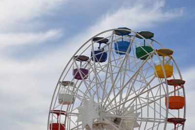 Low angle view of ferris wheel against sky - tibidabo, barcelona, spain