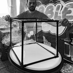 Portrait of boy standing by glass