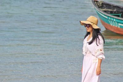 Woman standing on boat at sea shore