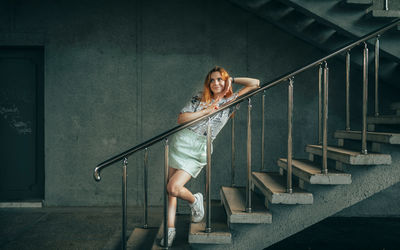 Low angle view of woman standing on staircase