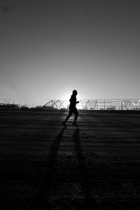 Low angle view of woman against clear sky