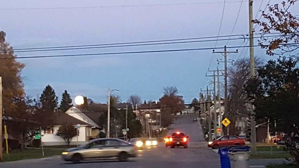 CARS ON ROAD AGAINST BUILDINGS