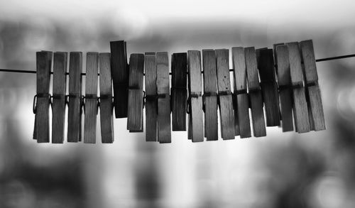 Close-up of wooden clothespins hanging on line