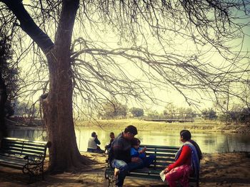 People sitting on road against sky