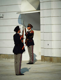 Friends standing against wall