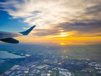 Aerial view of city against sky during sunset