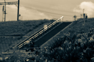 Railroad tracks on field against sky