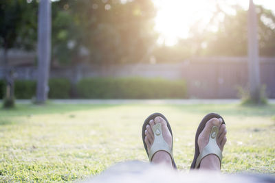 Low section of woman lying on field