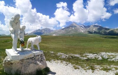 Statue on mountain against sky