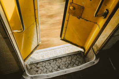 High angle view of yellow open bus door