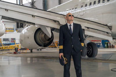 Rear view of businessman walking on airport