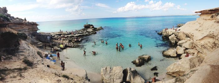 High angle view of people at beach against sky