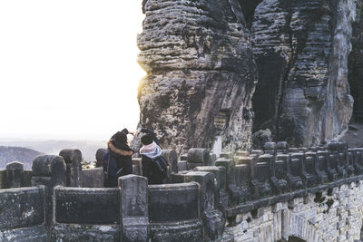 People sitting on rock