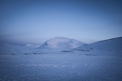 Pristine snow covered landscape and mountain in norway.