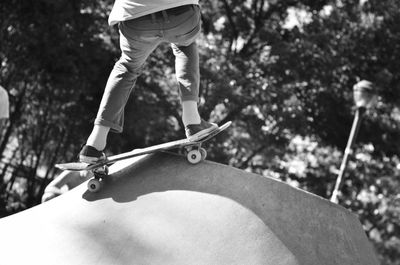 Low section of man skateboarding at park