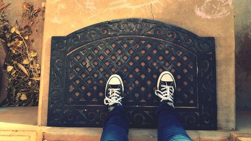 Low section of person standing on doormat