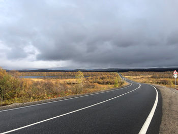 Road by landscape against sky