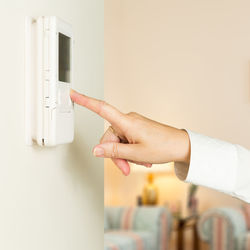 Cropped hand using intercom at home