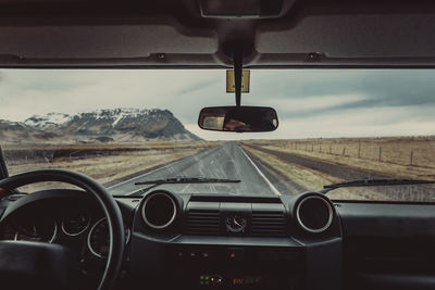 Car moving on road seen through windshield