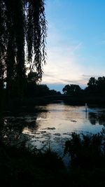 Scenic view of lake against sky at sunset