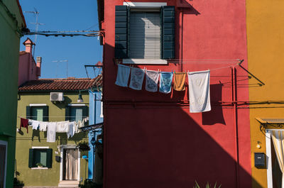 Low angle view of clothes drying against building