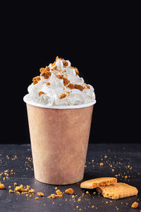 Close-up of dessert in glass against black background