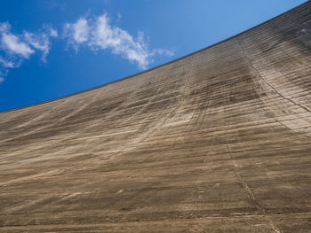 Low angle view of sand dunes against sky