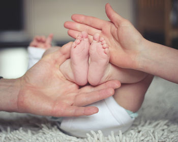 Close-up of mother holding baby hand