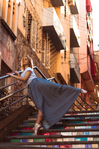 Side view of woman with umbrella in building