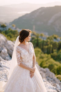 Rear view of woman standing on mountain